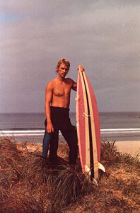 Randy Weldon with his shark- bitten surfboard, 1983.